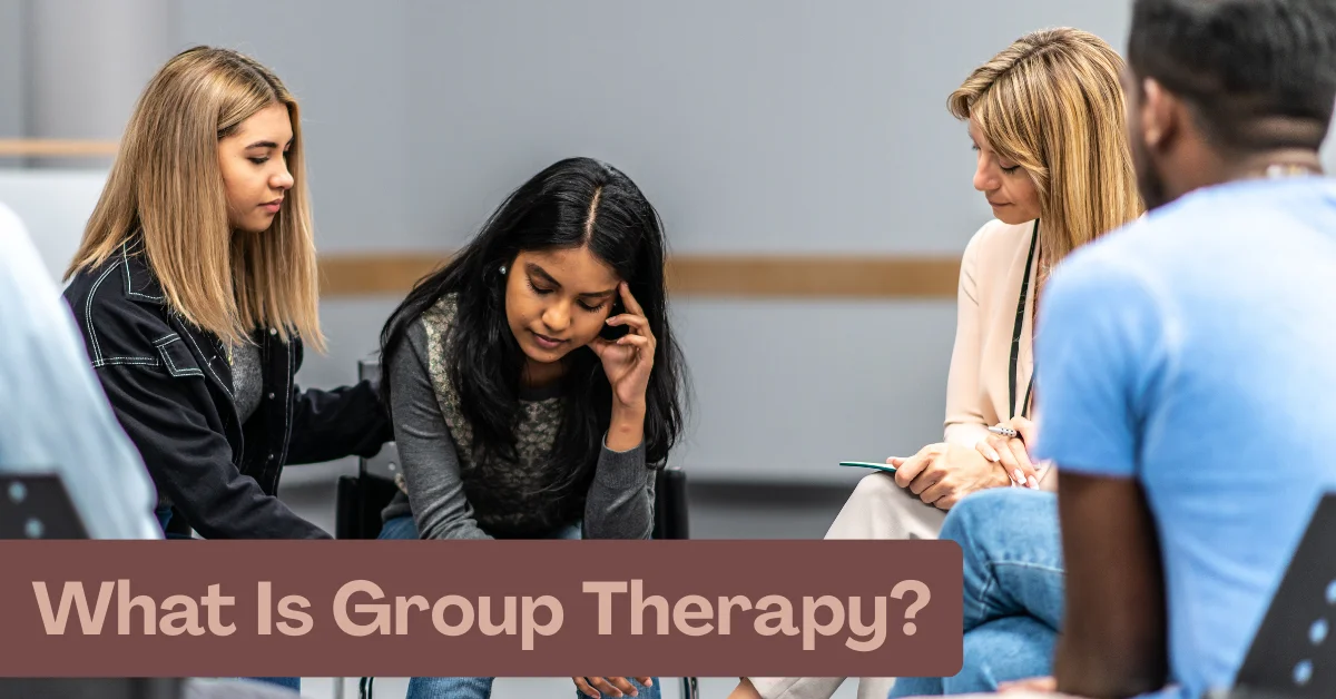People sitting in a circle during a group therapy session with a therapist
